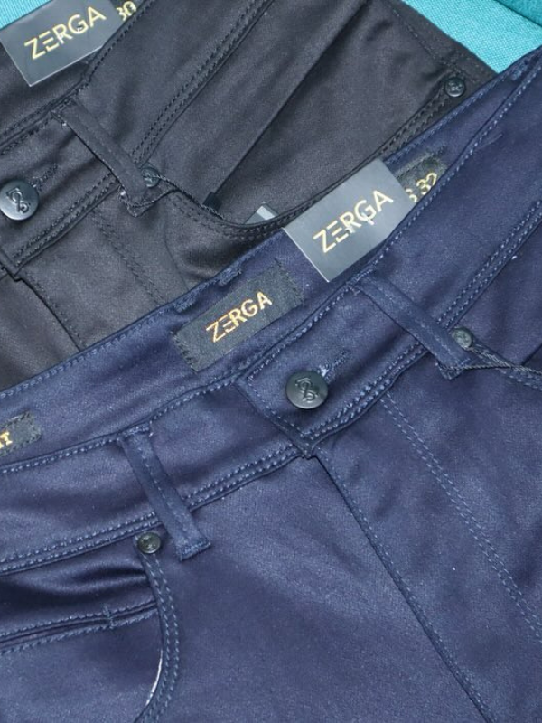 Assorted stylish men's bottoms including jeans, joggers, and chinos displayed neatly.